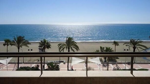 A balcony with a view of the beach and ocean. - Apartment With Stunning Sea Views And Vision Of The Rock Of 🇬🇮Gibraltar (Estepona)