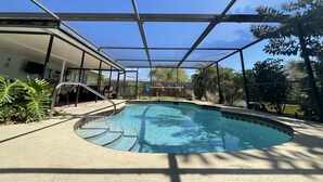 A covered outdoor swimming pool with a clear blue sky above. - Lakefront 2 Bd+Den,2bth With Heated Pool Near Siesta Key! (Sarasota)