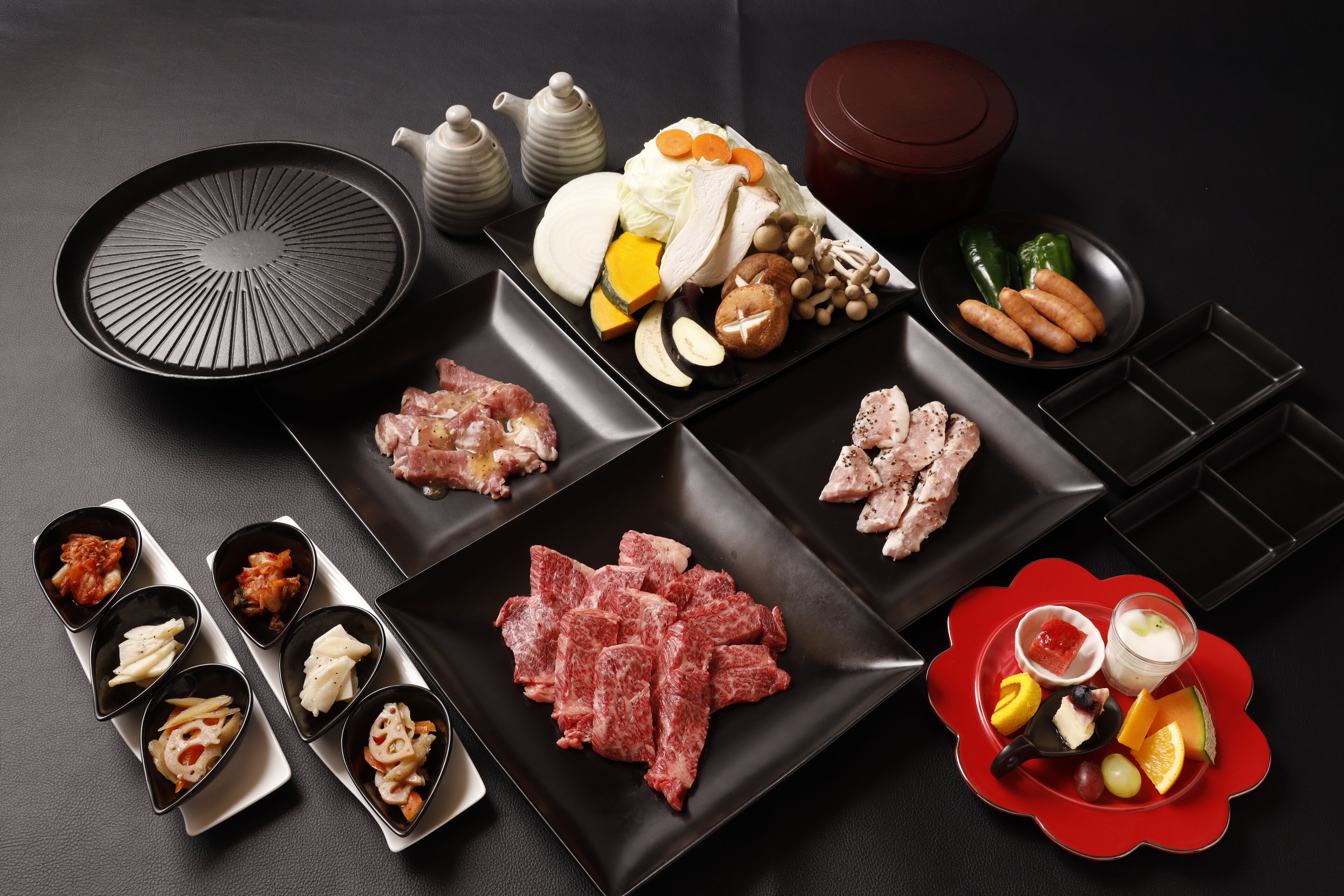 A variety of food items and kitchenware arranged on a table.