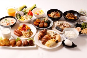 A variety of dishes including pasta, croissants, and rice.