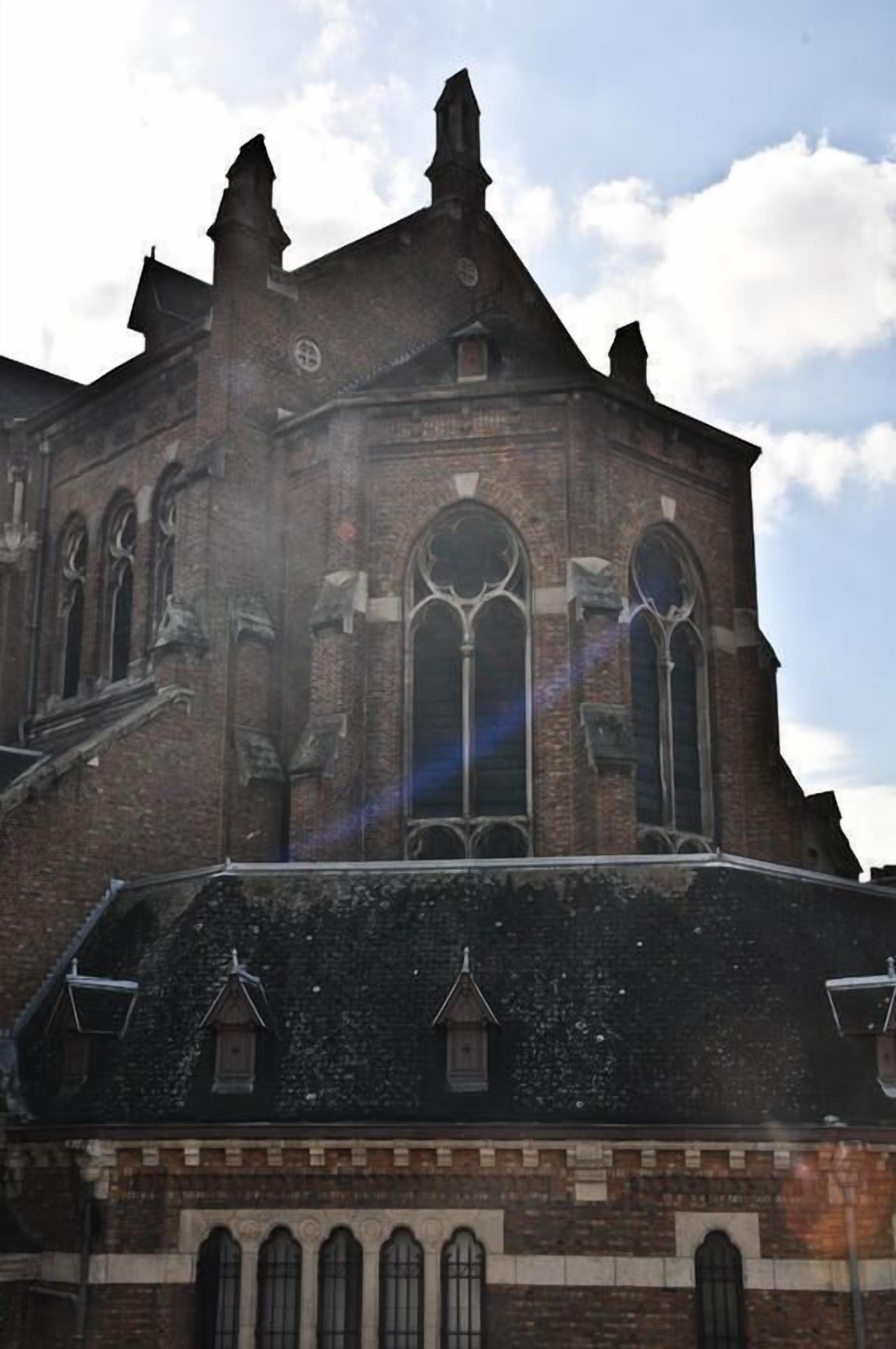 A historic building with a prominent tower, arched windows, and a brick facade.