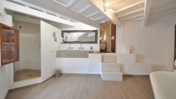 A modern bathroom with a large mirror, a bathtub, and a shower area. - Port Antic Ciutadella  by My Rooms Hotels (Ciutadella de Menorca)