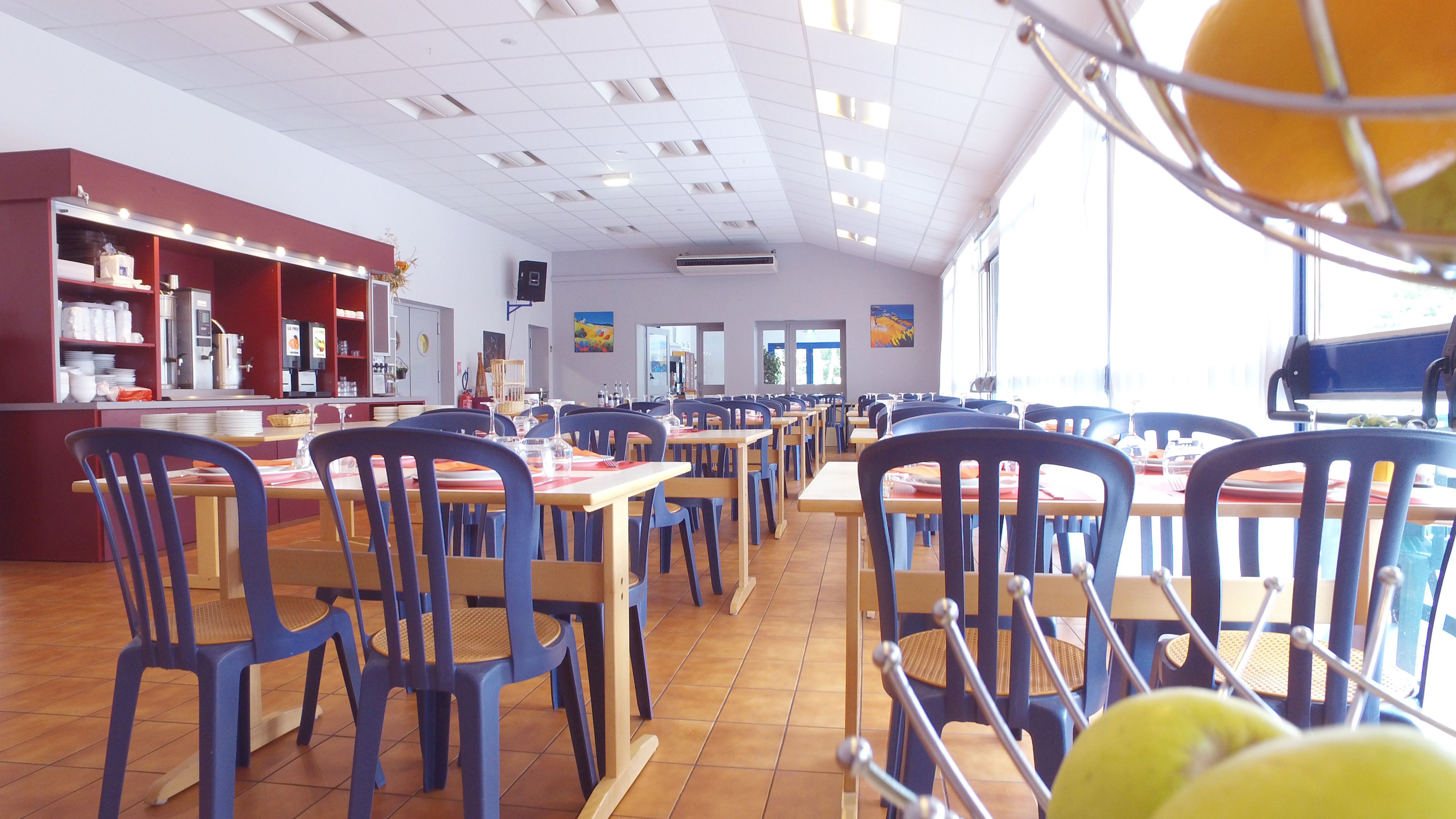 A spacious cafeteria with high ceilings, ample natural light, and a variety of seating arrangements.