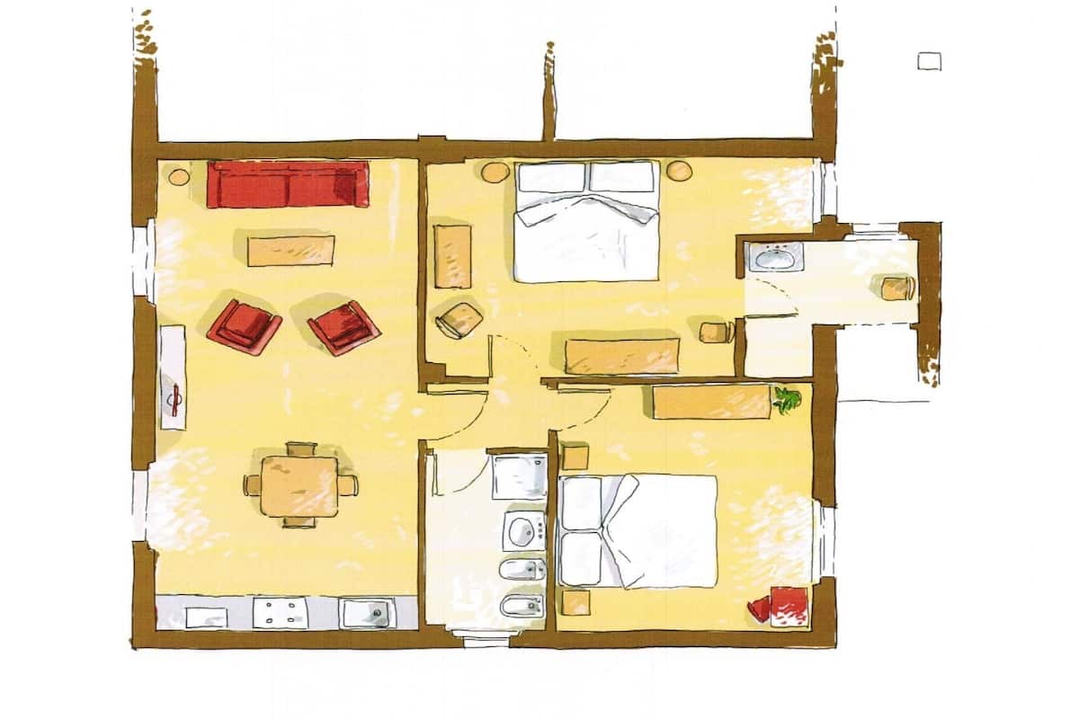 A floor plan of a hotel room with a bed, a desk, a chair, a small table, and a sofa.