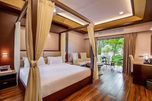 A four-poster bed with a canopy, a sitting area with chairs, and a view of greenery outside. - Black Thunder (METTUPALAYAM)
