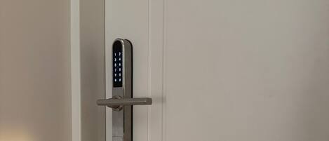 A modern door with a digital keypad lock.