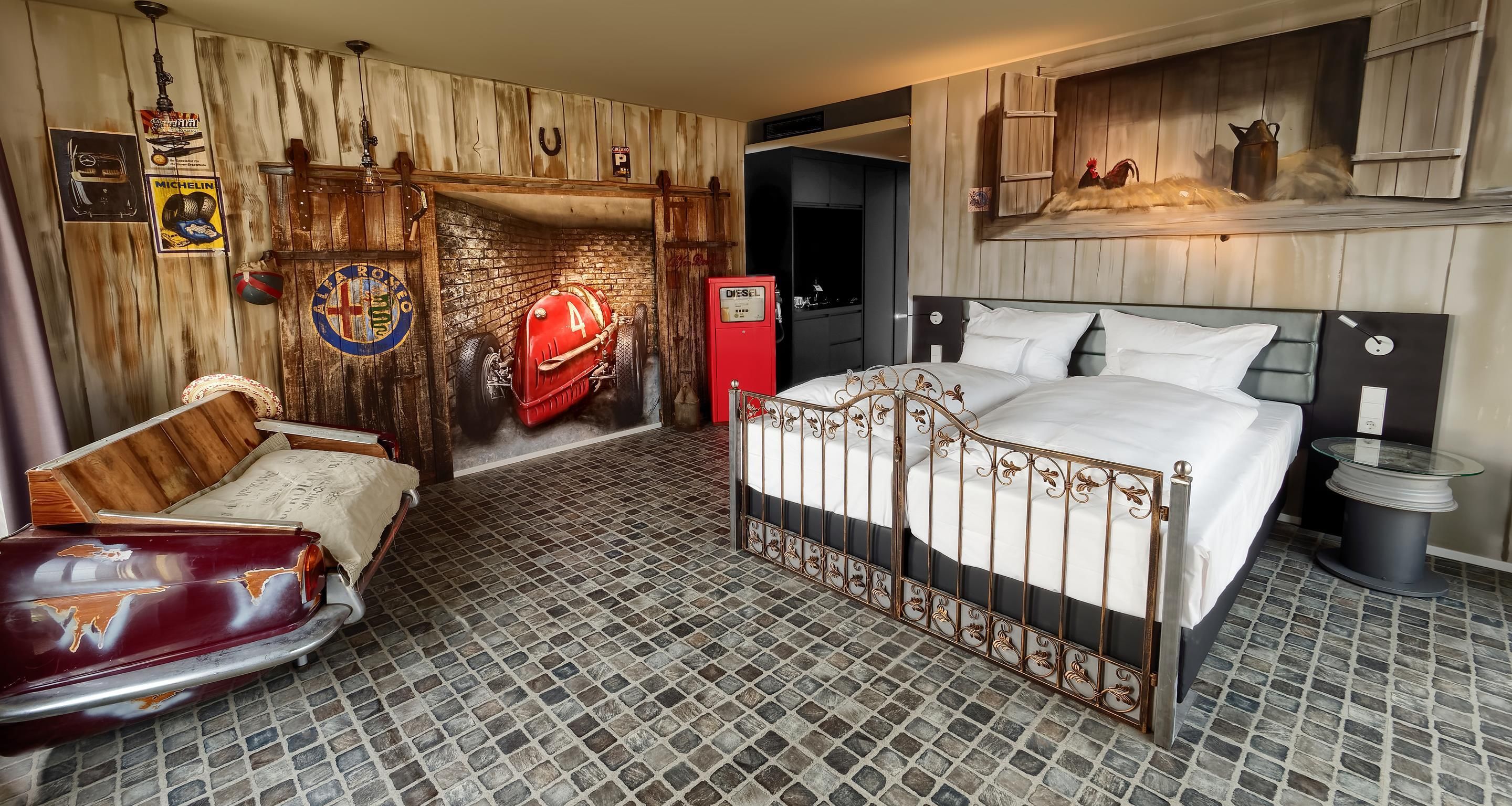 A bedroom with a vintage car-themed decor, a brick-patterned floor, and a bed with a metal frame.