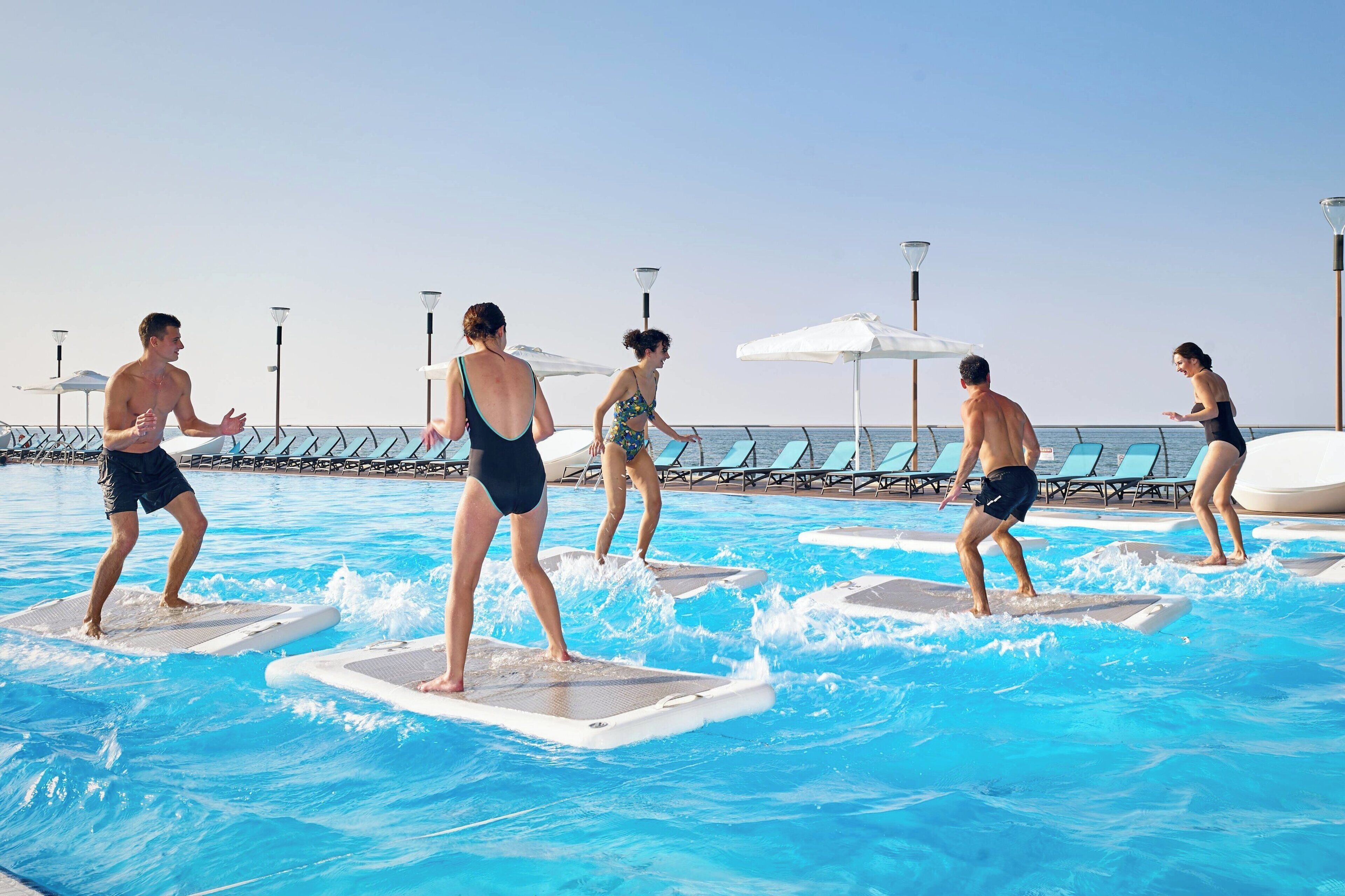 A swimming pool with people using water treadmills.