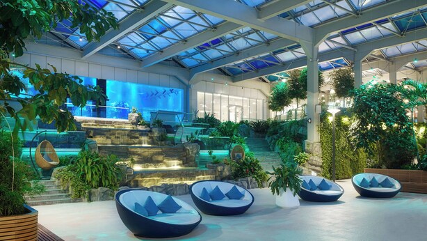 A spacious indoor area with a high ceiling, large windows, and a central water feature. - Autograph Collection Paragraph Resort & Spa Shekvetili (Shekhvetili)