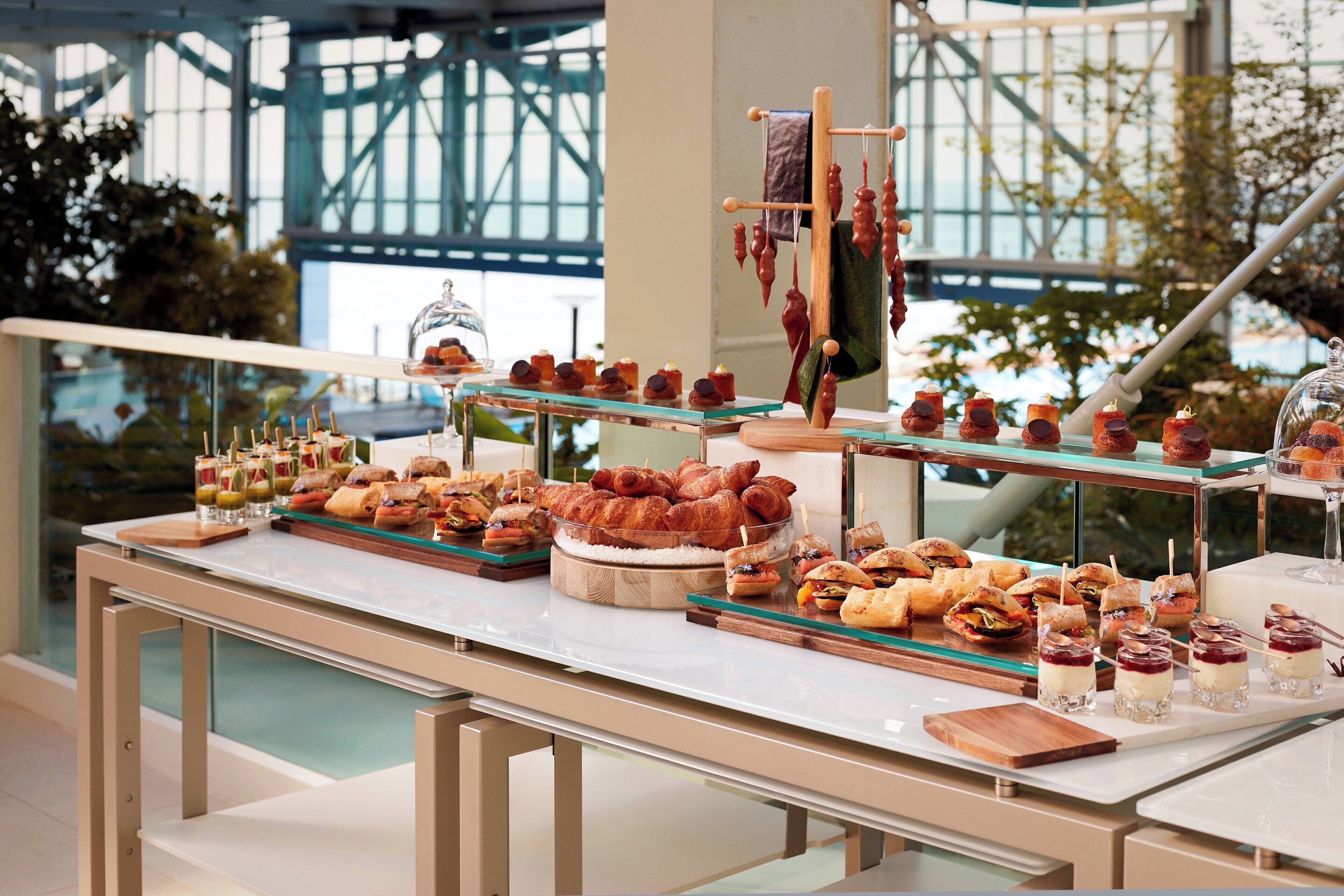 A buffet setup with various food items and a glass display case.