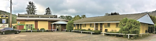 A two-story building with a restaurant on the ground floor and a lounge on the upper floor. There is a car parked in front of the building.