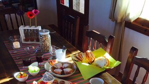 A dining table set with various breakfast items, including pastries, fruits, and beverages. - S'hort den Carrio (Ses Salines)