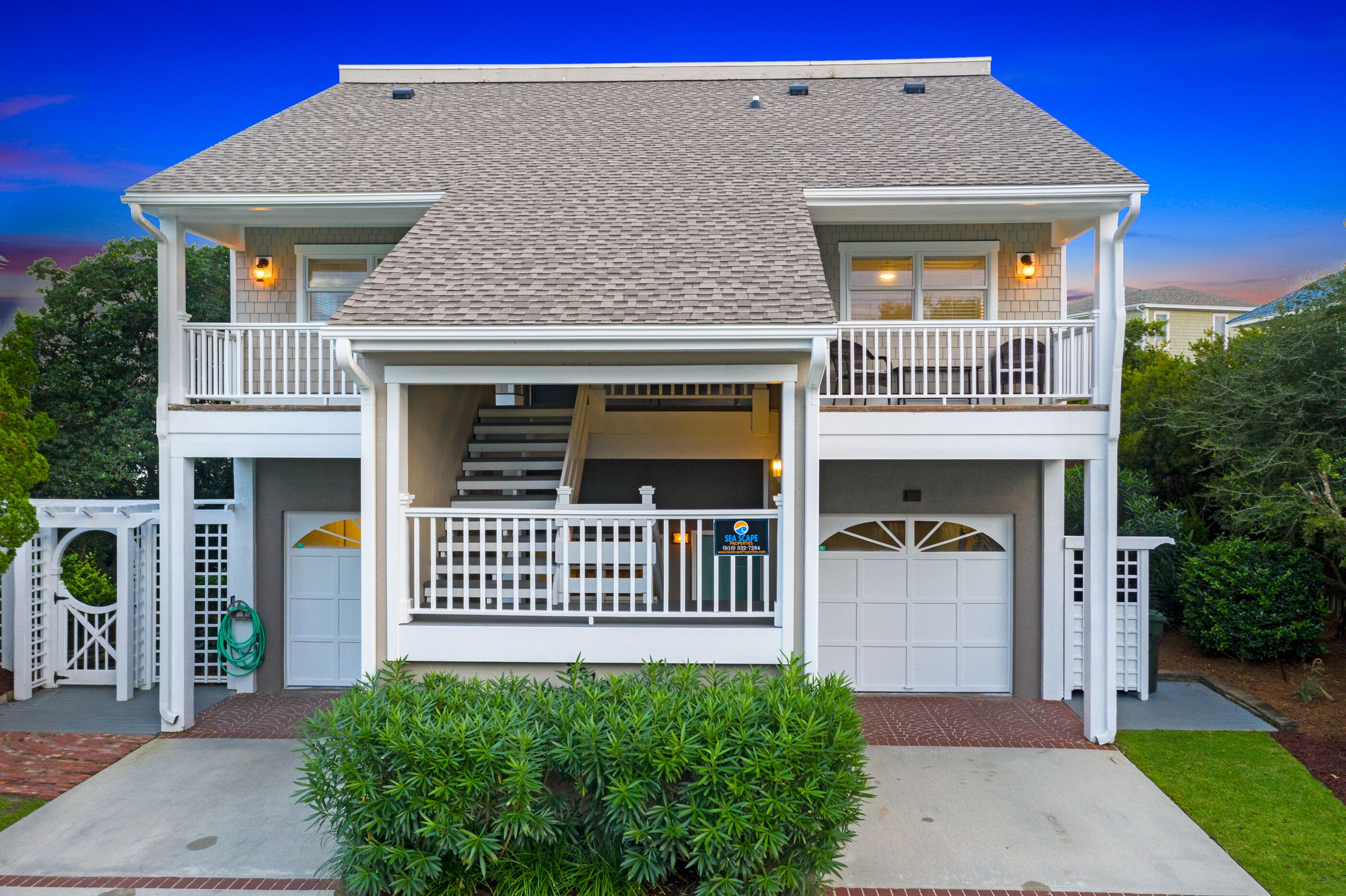 A two-story house with a front porch, a staircase, and a garage.