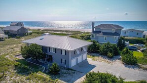 A coastal residential area with houses, a beach, and a clear sky. - Wrightsville Beach Coastal Retreat (Wrightsville Beach)