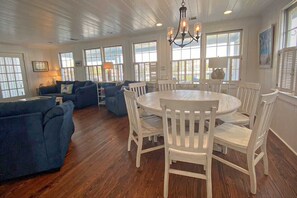 Relax in this inviting living area with a round dining table and comfortable seating for all.