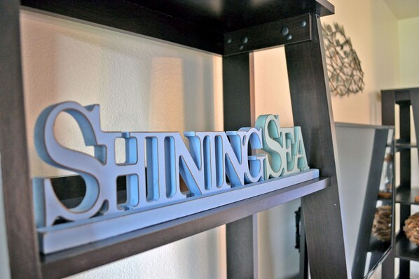 A sign with the words "SHININGSEA" in a modern font.