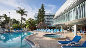 A pool area with multiple lounge chairs and a hot tub. - 205E La Brisa-2BR 2BA beachfront condo w/parking, shared pool, grills (Key West)