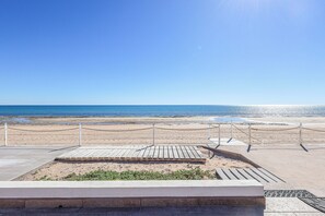 A beach view with a wooden deck and a chain barrier. - Kasa Kris: Enjoy the beach and ocean view from this cozy beachfront home (Puerto Peñasco)
