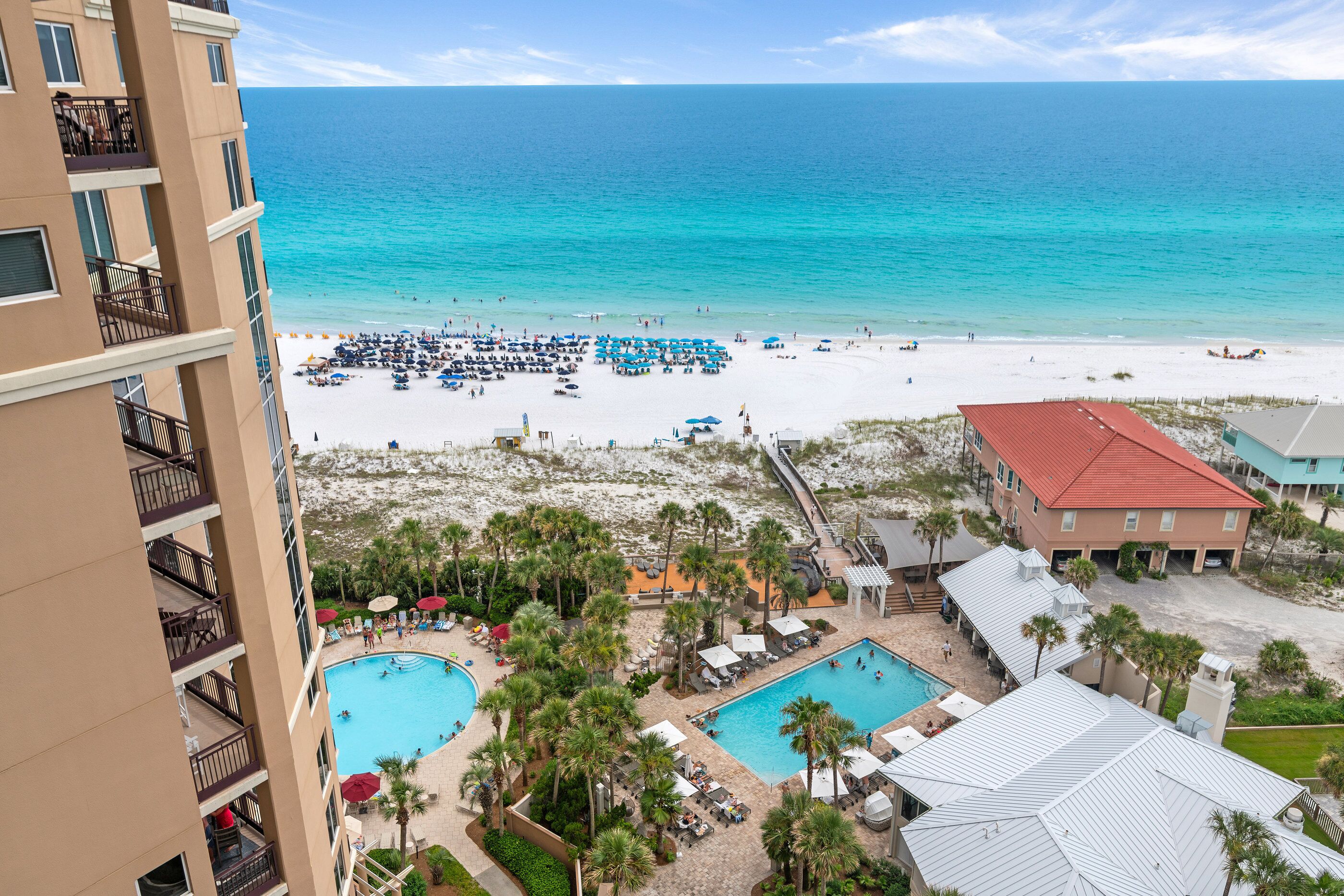 A resort with a pool, beach, and ocean view.
