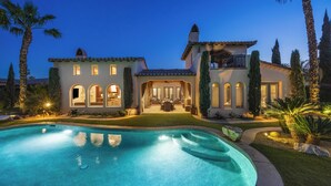 A large house with a swimming pool, a patio, and a well-maintained lawn. - Cappella - Gorgeous 4 br Villa in PGA West with Pool/Spa + Golf Course Views #259222 (La Quinta)