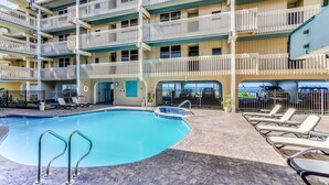 A multi-story hotel with a swimming pool, outdoor seating, and balconies. - Kona Bali Kai 317 Direct Oceanfront, Major Upgrade with Central Air. (Kailua Kona)