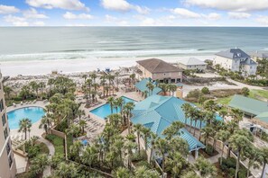 A resort with a pool, beach, and ocean view.