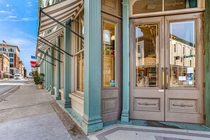 A historic building with large windows and a classic facade. - Contemporary Living on Broughton with King Beds & Parking by Lucky Savannah (Savannah)