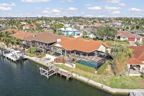 A residential area with houses, a dock, and a swimming pool.