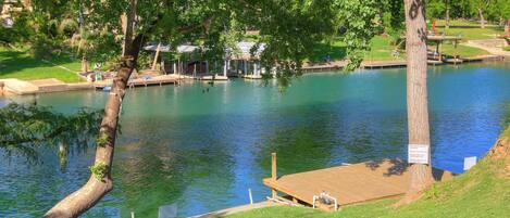 Escape to a serene lakeside retreat surrounded by lush greenery and a tranquil pavilion.