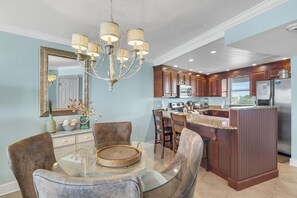 A modern kitchen with wooden cabinets, stainless steel appliances, and a central island.