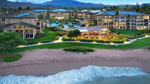 A resort with multiple buildings, a swimming pool, and a beach. - H404 - Ocean View Penthouse Suite with AC - Pool, Hot Tub, & Spa - Walk to shops (Kapaa)