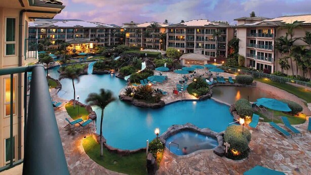 A resort with multiple swimming pools, lounge areas, and a large building complex. - H404 - Ocean View Penthouse Suite with AC - Pool, Hot Tub, & Spa - Walk to shops (Kapaa)