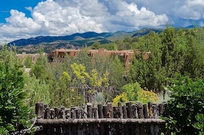 A view of a mountainous landscape with buildings in the foreground.
