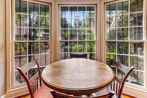 Enjoy meals and social gatherings in this well-lit dining area with a round table and four chairs.