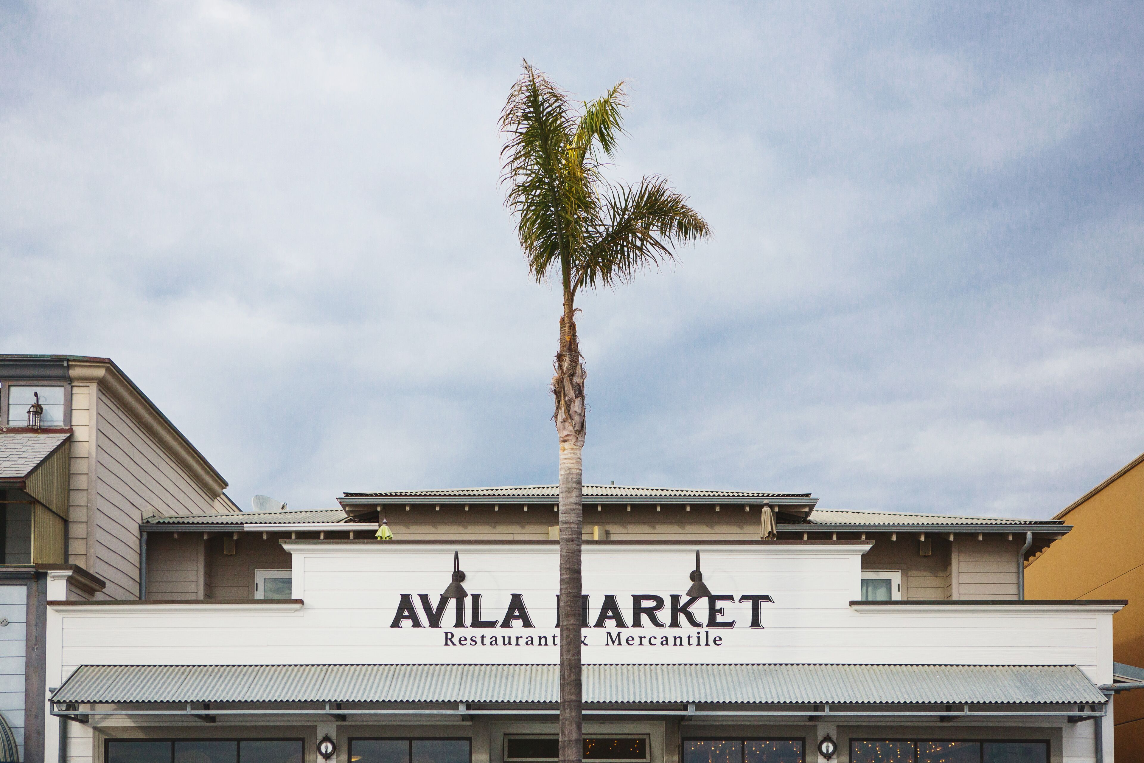 A building with a sign that reads 'AVILA MARKET Restaurant & Mercantile.'