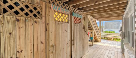 A wooden deck with a wooden fence and two signs labeled "WASHER" and "DRYER".