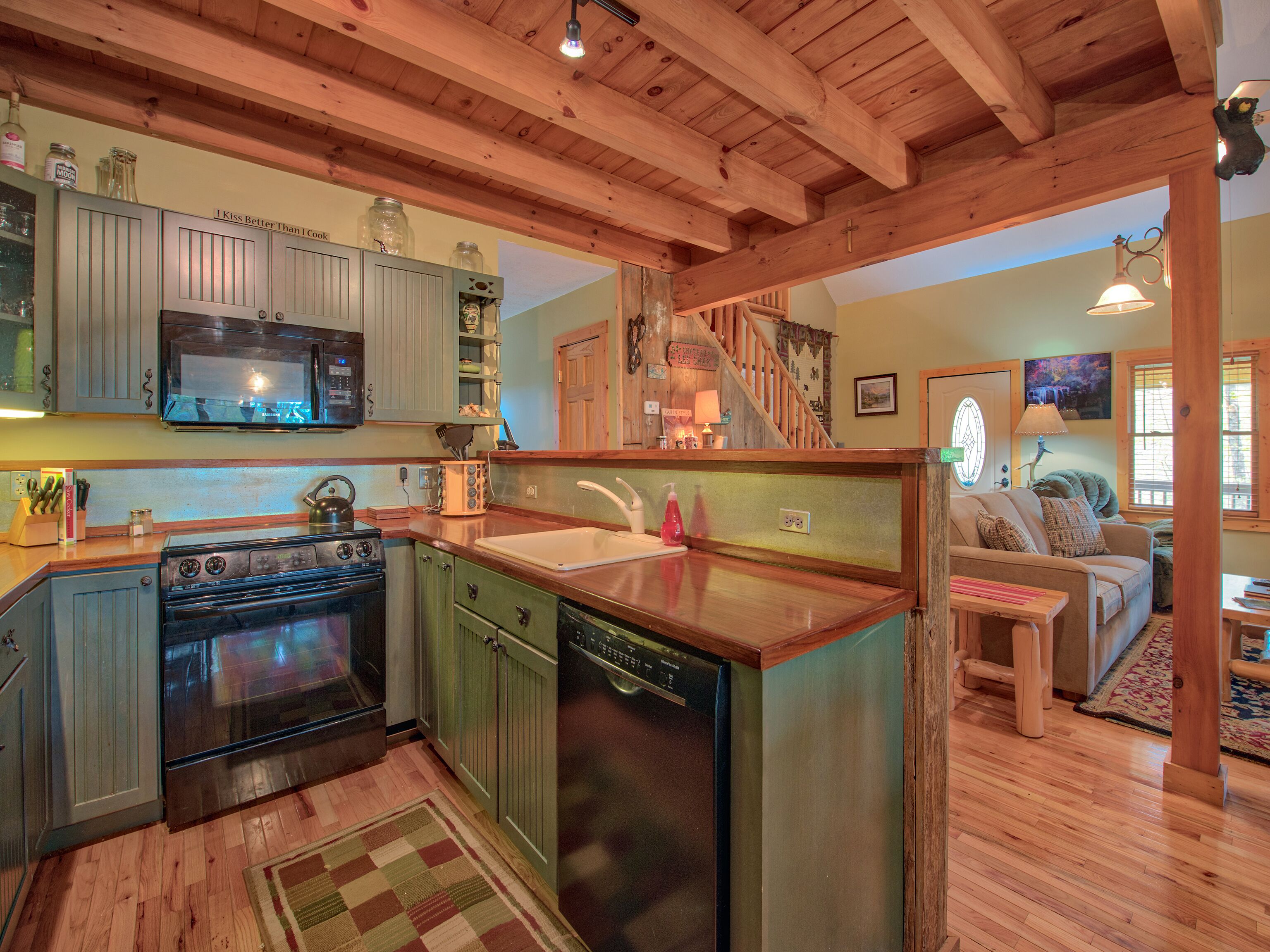 A kitchen with wooden cabinets, a microwave, a stove, and a dishwasher.