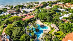 A resort with a large swimming pool, beachfront views, and lush greenery. - Matapalo 606♆ Amazing Ocean views on the center of town ♆ (Tamarindo)