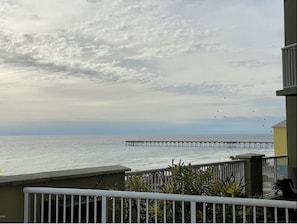 A balcony with a view of the sea and a pier. - Renovated with Gulf View Free Beach Chairs, Golf, & Activities Daily! (Panama City Beach)