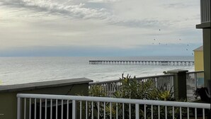A balcony with a view of the sea and a pier. - Renovated with Gulf View Free Beach Chairs, Golf, & Activities Daily! (Panama City Beach)
