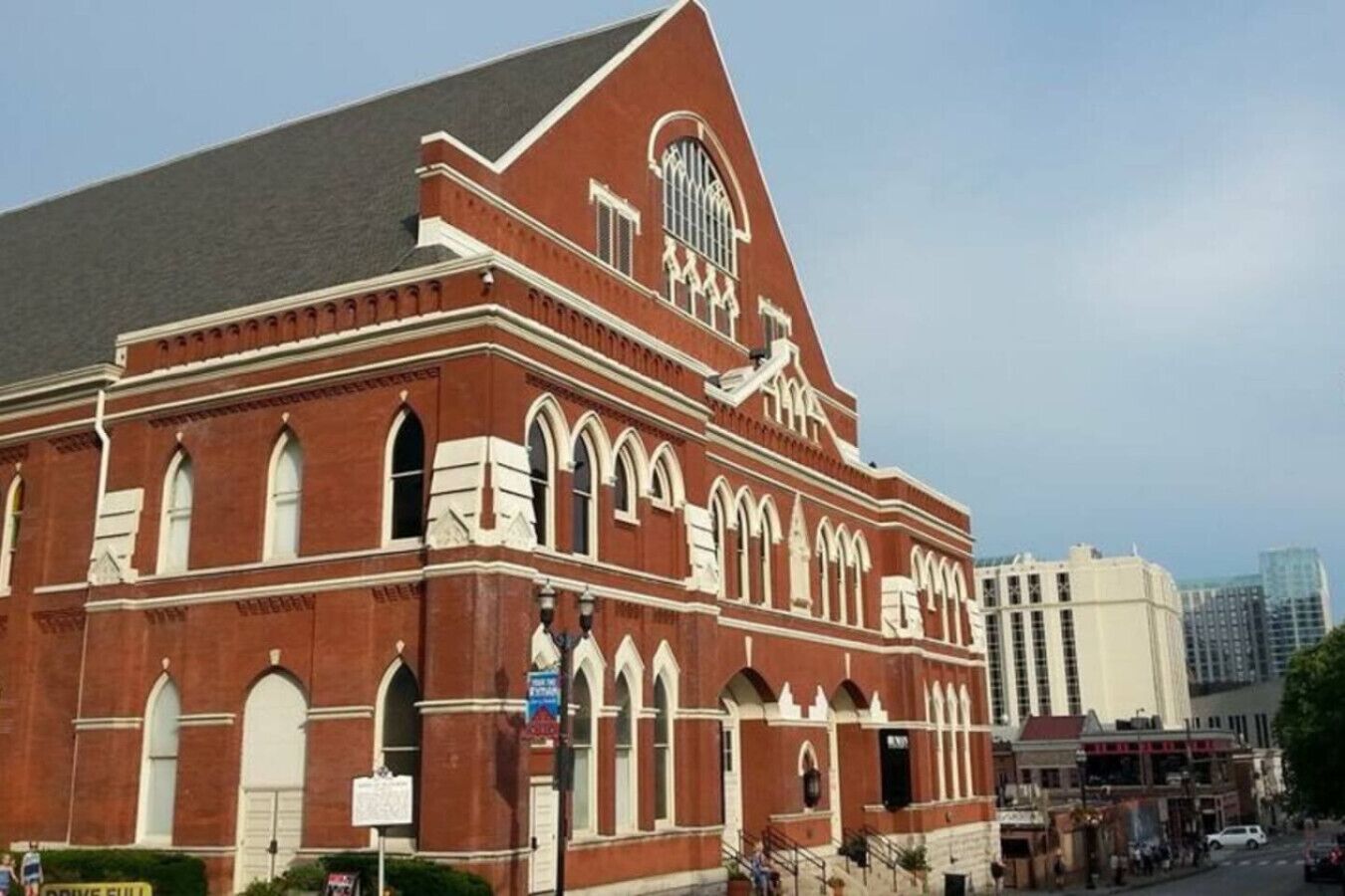 A large, red-brick building with arched windows and a prominent clock tower.