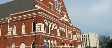 A large, red-brick building with arched windows and a prominent clock tower.