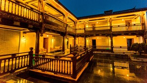 A traditional building with multiple balconies and a central courtyard. - Wangshan Travelling With Hotel (Lijiang)