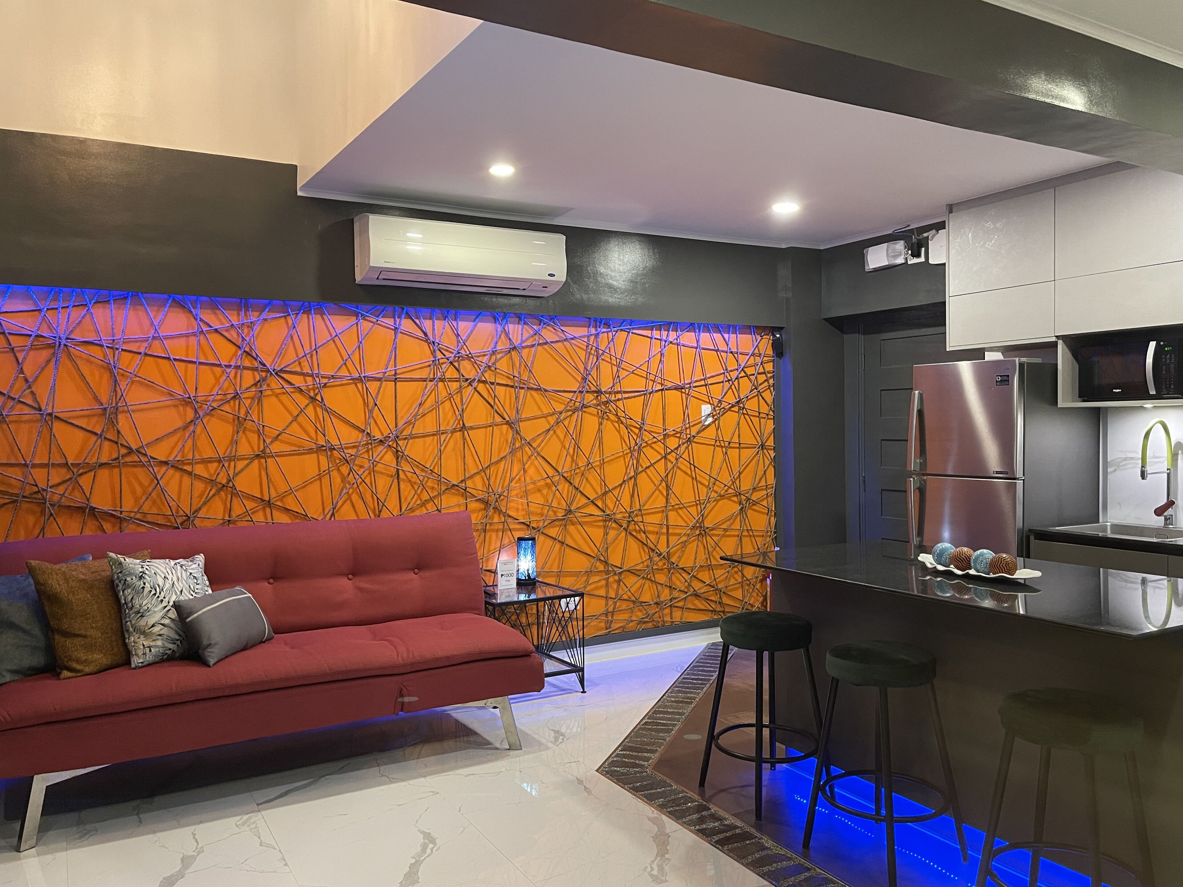 A modern kitchen with a built-in refrigerator, a microwave, and a sink.