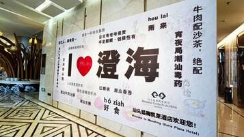 A hotel lobby with a large sign featuring Chinese characters and a heart symbol, indicating a focus on Chinese cuisine.