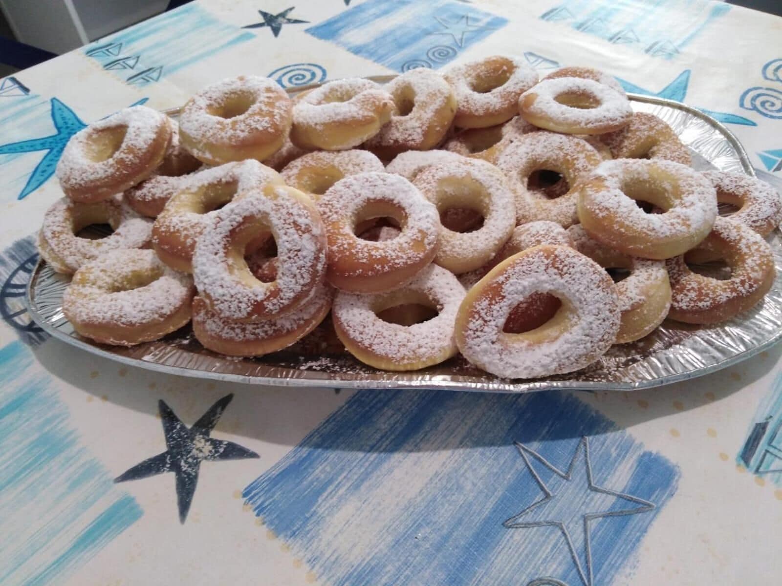 A tray of doughnuts on a table with a star pattern.