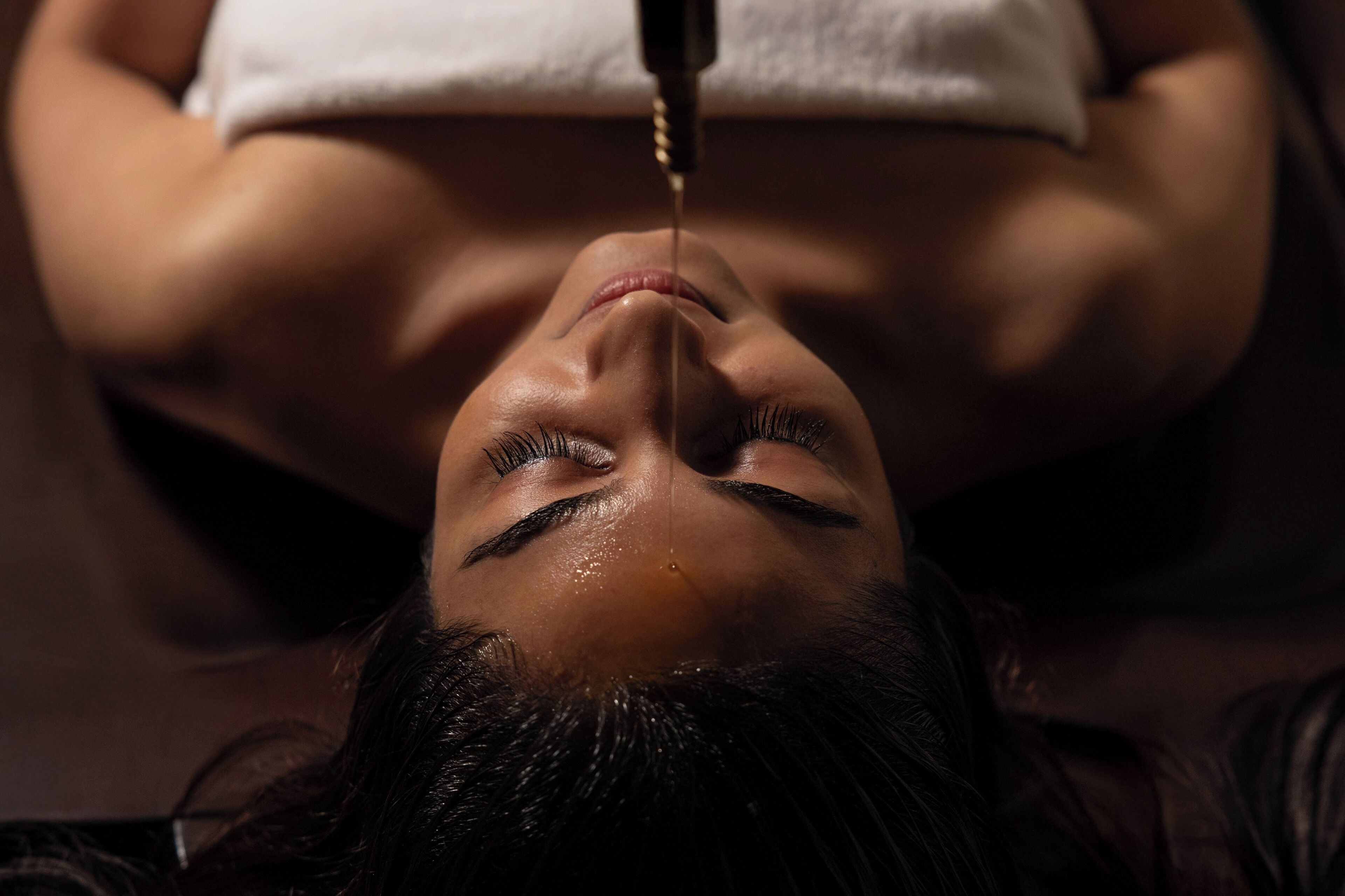 A person lying down with a device being used on their abdomen.