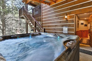 A hot tub with a wooden deck and stairs leading to a wooden cabin. - PICK'S RIVERSIDE RETREAT - 2 Bedroom plus Loft Riverside Retreat on the Upper Toccoa River (Blue Ridge)