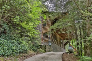 A pathway leading to a wooden staircase with a stone wall on one side and dense greenery on the other. - PICK'S RIVERSIDE RETREAT - 2 Bedroom plus Loft Riverside Retreat on the Upper Toccoa River (Blue Ridge)