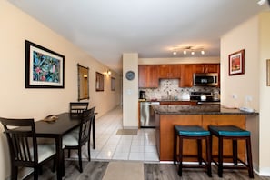 Enjoy meals in the kitchen with a central island and bar stools, or dine at the dark wood table with matching chairs.